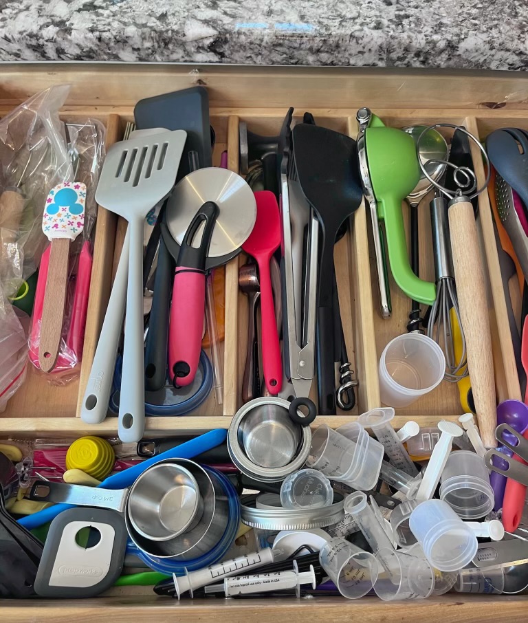 messy cluttered kitchen drawer with cooking and baking items
