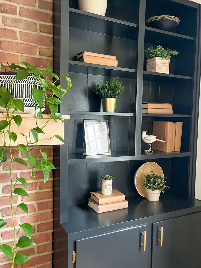 decluttered built in bookshelf with decor items