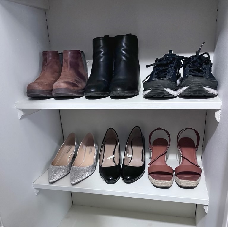 6 pairs of shoes sitting neatly on shelf