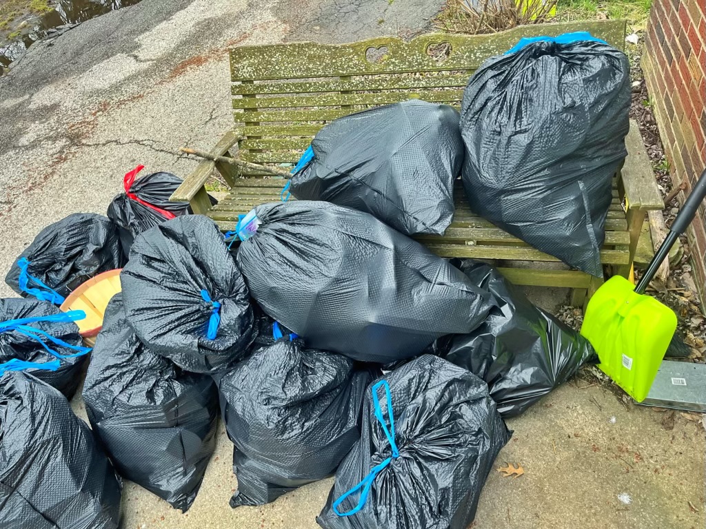 a pile of black trash bags filled with trash