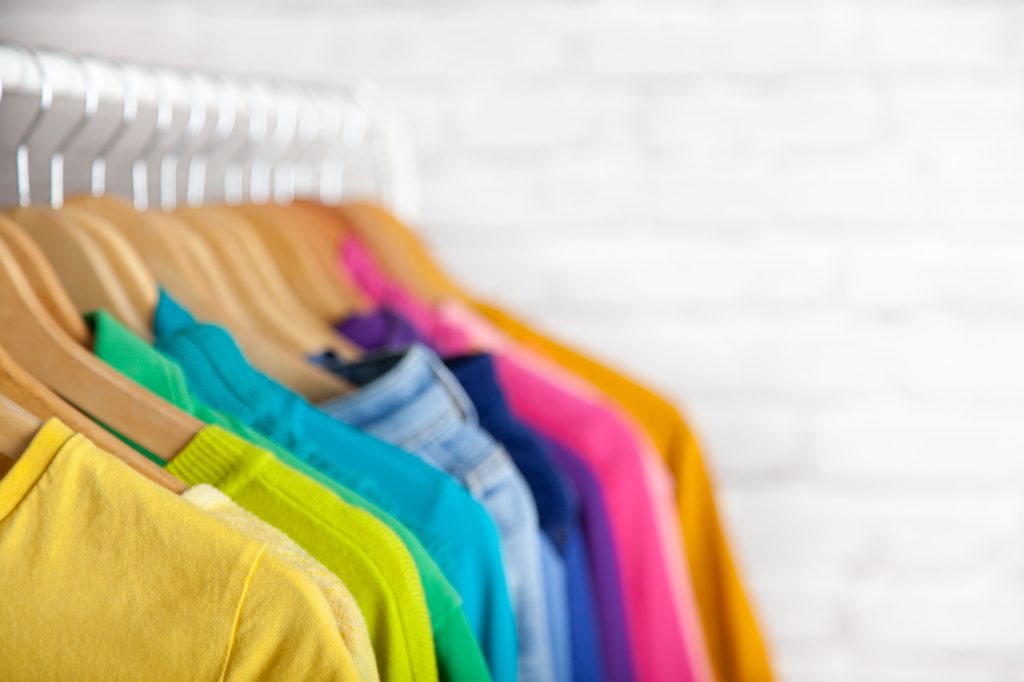 clothes hung and organized by color