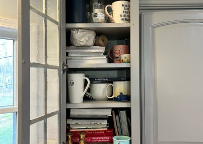 messy crammed upper kitchen cabinet