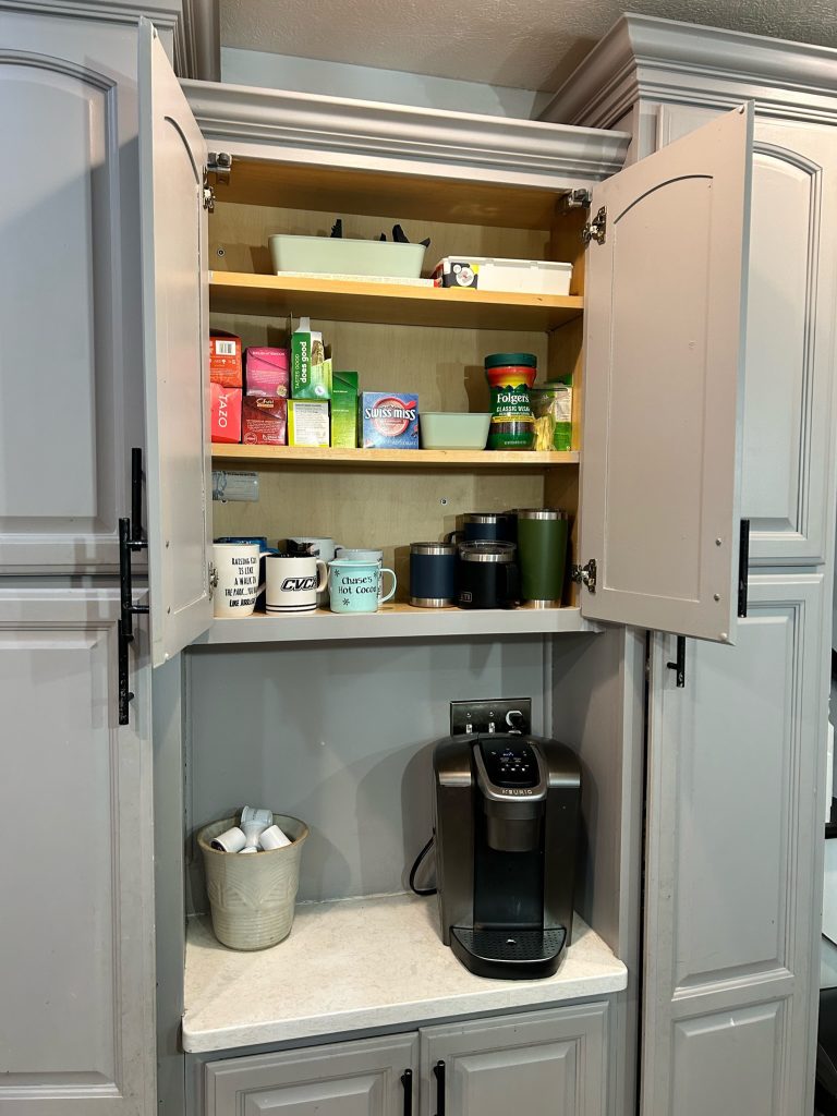neat, tidy, decluttered and organized cabinet above a counter with a coffee maker
