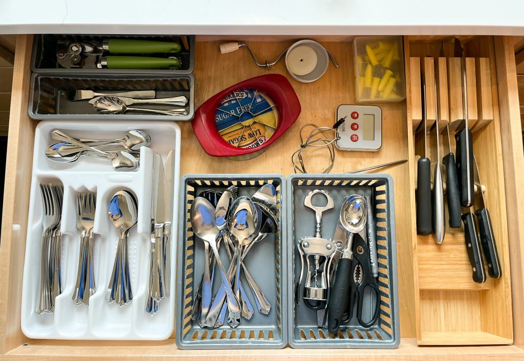 organized, decluttered and neat drawer of silverware and kitchen utensils