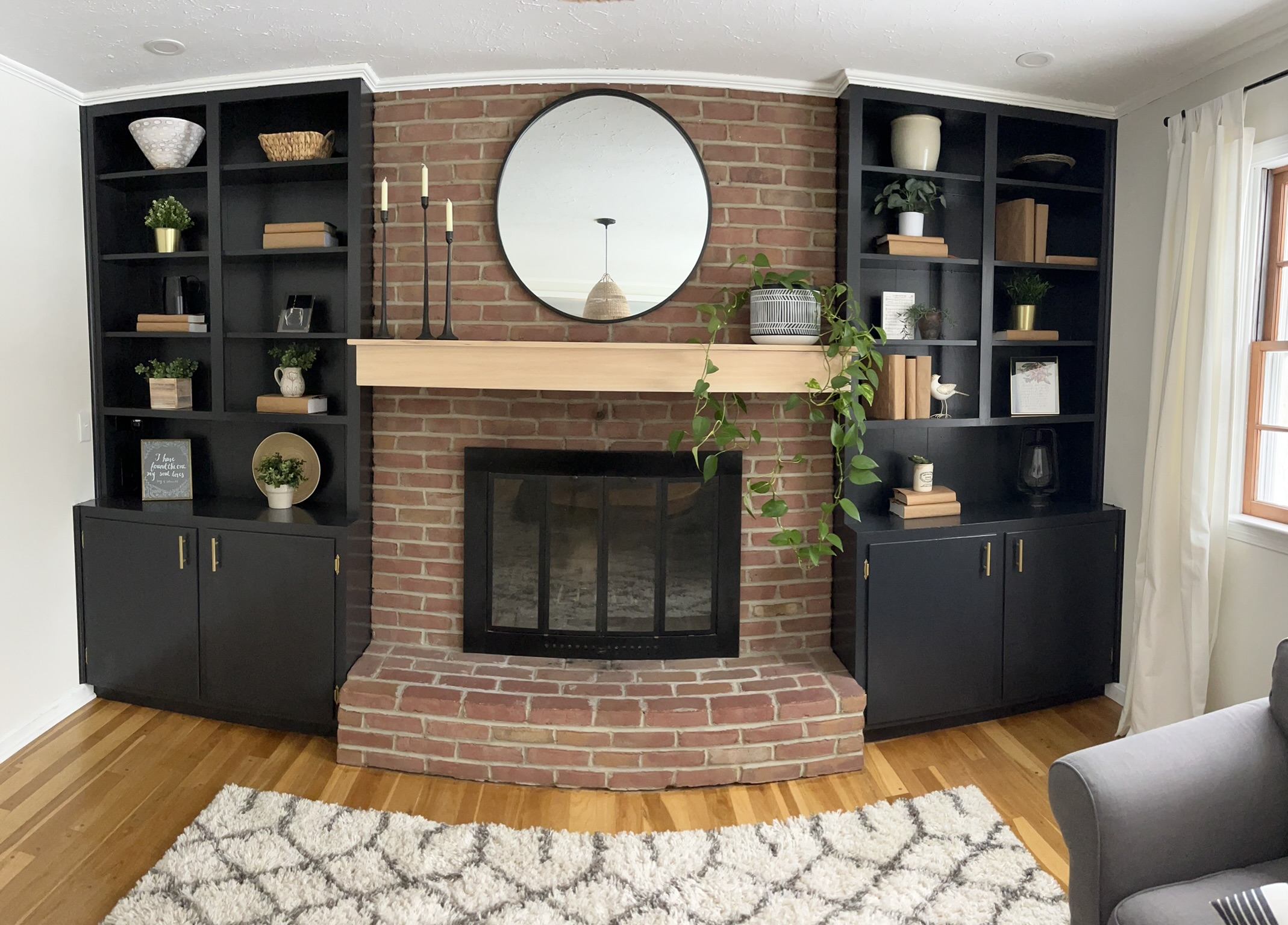 fire place with black built in book shelves