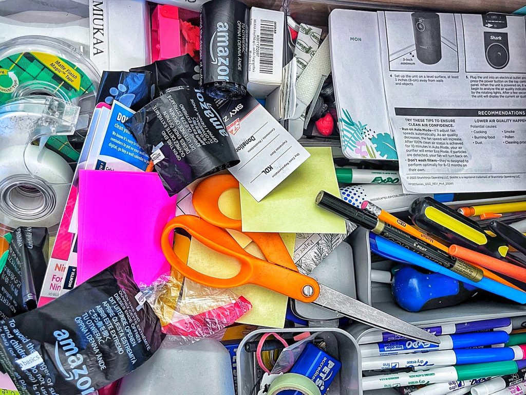 cluttered collection of junk drawer items 