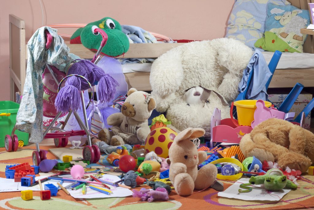 Childs room with bed and floor covered in toys, garbage and clutter