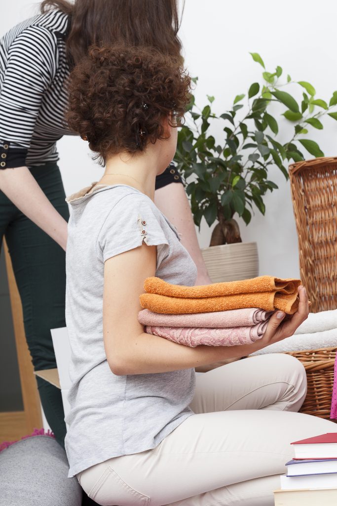 mom and daughter tidying up and cleaning together