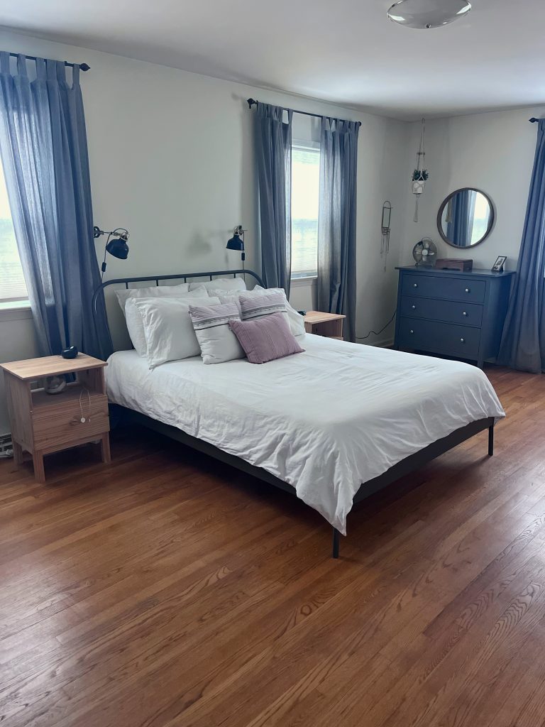 clean, serene, tidy bedroom with made bed